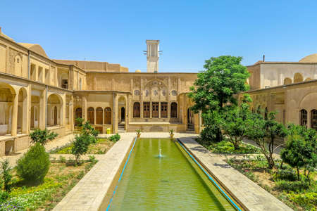 Kashan Boroujerd Historical House Courtyard Back View with Fountain Pond and Windcatcher Towerのeditorial素材