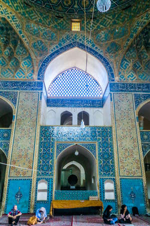 Yazd Masjid-e Jameh Mosque Interior with Blue Tiles Ornament and Sitting Peopleのeditorial素材