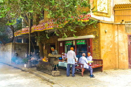 Kashgar Old Town Uyghur Men Preparing and Selling Lamb Skewers Street Foodのeditorial素材