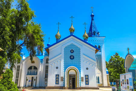 Bishkek Holy Resurrection Russian Orthodox Cathedral Blue Colored Roof with Three Golden Domed Crossesの写真素材
