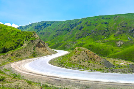 Toktogul Reservoir Lake Landscape with Suusamyr Too Mountain Range and Jeep on Highway