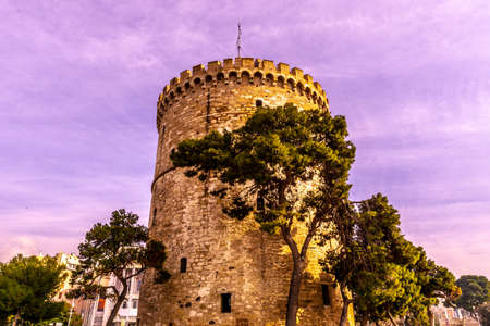 Thessaloniki White Tower Frontal View with Trees and Blue Sky Cloudy Backgroundのeditorial素材