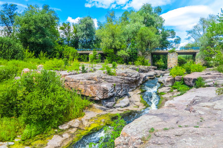 Buky Village Canyon at Hirskyi Tikych River with Waterfall and Bridge at Background