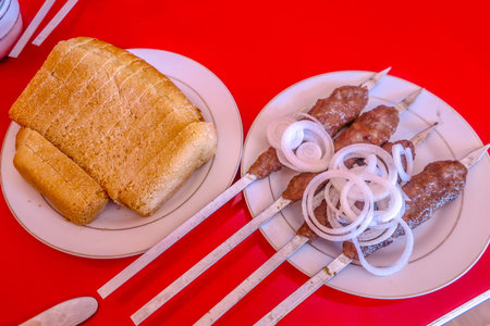 Uzbek Traditional Lamb Skewers with Chopped Onion Rings and Common Bread