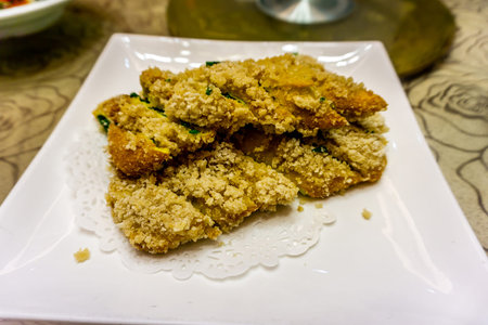Fried Chinese Jiucai Hezi with Crumbs on a White Plate