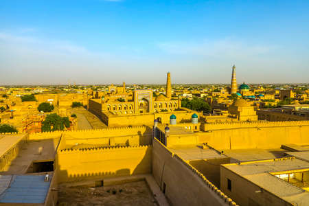 Khiva Old Town Kunya Ark Citadel Cityscape Viewpoint of Pahlavon Mahmoud Complex Juma Mosque Minaret at Sunsetの写真素材