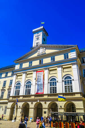Lviv Town Hall Side Low Angle View with Waving Ukrainian Flag on Roofのeditorial素材