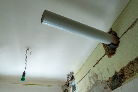 Open Sewage Pipe Under Construction Hanging on White Color Painted Ceiling with Common Old Fashioned...