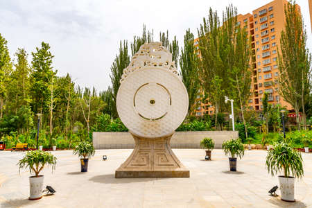 Hotan Picturesque Kunlun Lake Park Circle Shaped Sculpture with Dragons Frontal View on a Cloudy Blue Sky Dayのeditorial素材