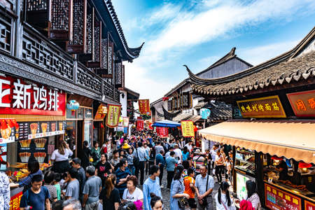 Shanghai Nanxiang Old Town Canal City Picturesque Shopping Street with Walking People on a Sunny Blue Sky Dayのeditorial素材