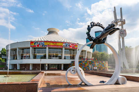 Almaty Kazakh State Circus Frontal View of a Leopard Statue Jumping Through Fire Rings and a Fountain on a Sunny Blue Sky Dayのeditorial素材