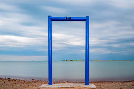 Kapchagay Reservoir Lake Picturesque Breathtaking Long Exposure View of Beach Portal Gate on a Cloudy Dayの写真素材