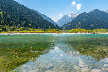 Esik Lake Issyk Picturesque Breathtaking View with Snow Capped Mountains on a Sunny Blue Sky Dayの写真素材