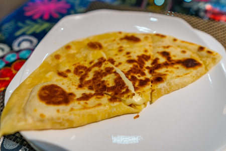Traditional Mouthwatering Caucasian Georgian Khachapuri Cheese Bread Dish on a White Plate