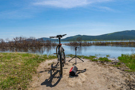 Burabay Borovoe National Park Breathtaking Shchuchye Lake Shore View with Bicycle and Tripod on a Sunny Blue Sky Dayの写真素材