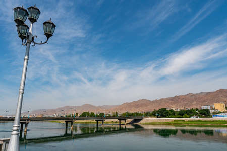 Khujand Syr Darya River Picturesque Breathtaking View from a Bridge on a Sunny Blue Sky Dayの写真素材