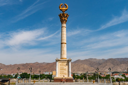 Khujand Stella with Patriotic Inscriptions and Tajikistan Coat of Arms on a Sunny Blue Sky Dayの写真素材
