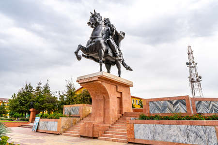 Qurghonteppa Bokhtar Ismoil Somoni Square Low Angle View of Statue on a Cloudy Rainy Dayの写真素材
