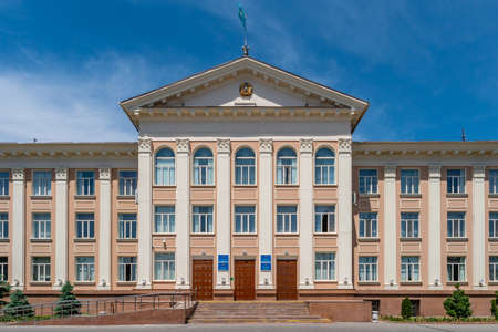Taraz Akimat City Hall with Waving Kazakhstan Flag on Top of Roof Picturesque Breathtaking View on a Sunny Blue Sky Dayのeditorial素材