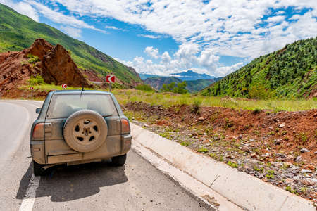 Kulob to Qalai Khumb Pamir Highway Picturesque Breathtaking Landscape View of SUV Jeep on a Sunny Blue Sky Dayのeditorial素材