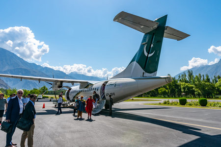 Gilgit Domestic Airport Pakistan Airlines Passengers are Exiting the Plane on a Sunny Blue Sky Day