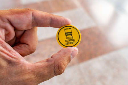 Islamabad Rawalpindi Metro Bus Station Centaurus South at Blue Area Closeup View of Yellow Colored Token Ticketの写真素材