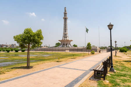 Lahore Iqbal Park Minar-e-Pakistan National Monument Picturesque View with Waving Pakistan Flag on a Sunny Blue Sky Dayの写真素材