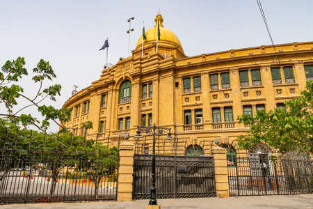 Karachi Port Trust Building KPT Picturesque with Waving Pakistan Flag on Top of Roof on a Cloudy Dayの写真素材