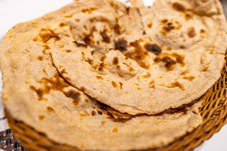 Traditional Two Mouthwatering Pakistani Fresh Hot Tandoori Roti Breads Served in a Basketの写真素材