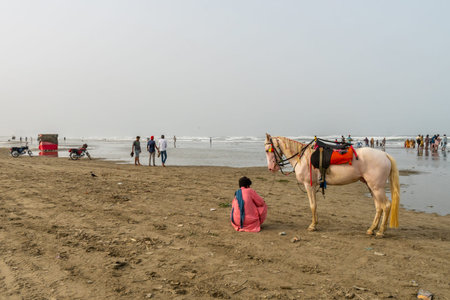 Karachi Clifton Beach Breathtaking Picturesque View of Guy with a White Horse at Morning on a Cloudy Dayの写真素材