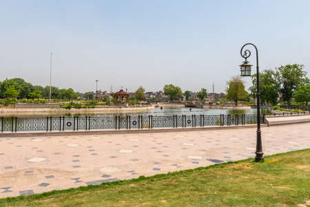 Lahore Iqbal Park Picturesque View of a Pond with a Pavilion on a Sunny Blue Sky Dayの写真素材
