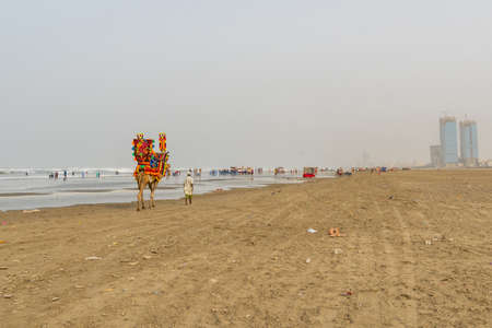 Karachi Clifton Beach Breathtaking Picturesque View of a Guy with a Camel at Morning on a Cloudy Dayの写真素材