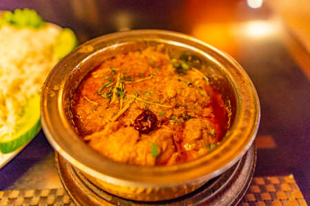 Traditional Mouthwatering Pakistani Orange Colored Spicy Lamb Curry Served in a Bowlの写真素材