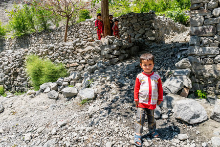 Gillgit to Skardu Sassi Village Smiling Little Boy is Looking at Camera Lens on a Sunny Blue Sky Dayのeditorial素材