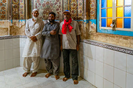Hyderabad Sarfaraz Khan Kalhoro Shrine Picturesque Interior View of Three Pakistani Pilgrims on a Sunny Blue Sky Dayのeditorial素材
