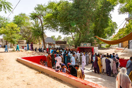 Sukkur Hazrat Syed Sadar Ur Din Shah Tomb at Bukkur Island Picturesque View of Muslim Pilgrims Taking Off their Shoes During Eid Al Fitr on a Sunny Blue Sky Dayのeditorial素材