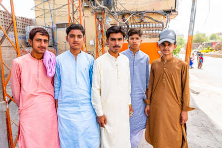 Sukkur a Couple of Young Pakistani Guys Dressed in Shalwar Kameez is Curiously Taking a Photo on a Sunny Blue Sky Dayのeditorial素材