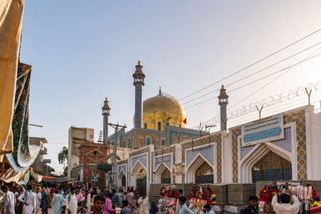 Sehwan Sharif Shrine of Hazrat Lal Shahbaz Qalandar Picturesque View with Walking People at a Bazaar...