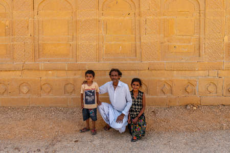 Makli Hill Necropolis UNESCO World Heritage Site Picturesque View of a Father with his Two Children on a Sunny Blue Sky Dayのeditorial素材