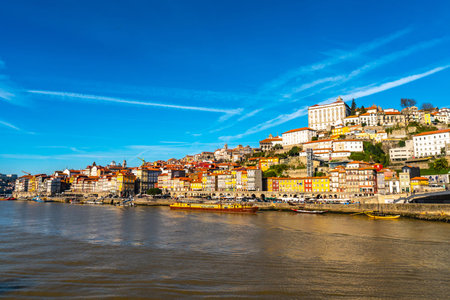 Porto Douro River Picturesque View of Ribeira District with Anchored Ships on a Sunny Blue Sky Day...