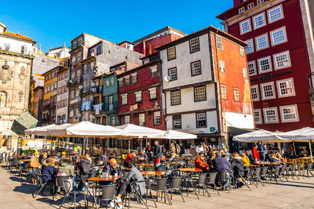 Porto Ribeira Square Breathtaking Picturesque View of People at Restaurants and Cafes on a Sunny Blue Sky Day in Winterのeditorial素材