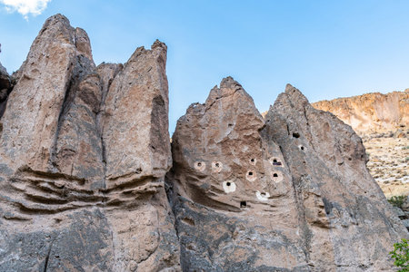 Soganli Valley Breathtaking Picturesque View of Rock-Cut Houses and Cloisters on a Blue Sky Day in...