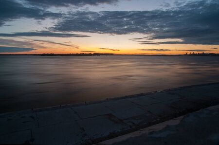 Orange sunset river landscape with low shutter speedの写真素材