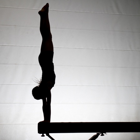 silhouette of gymnast on balance beamの写真素材