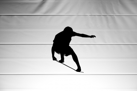 silhouette with board on trampolineの写真素材