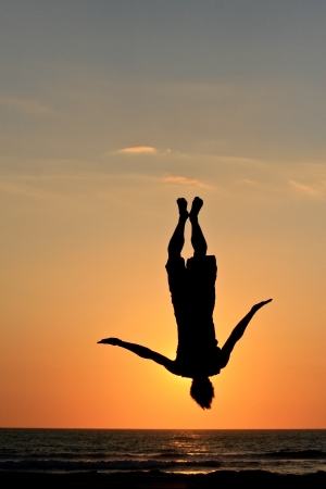 sunset jump on beach in sunsetの写真素材