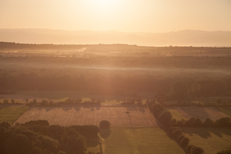 sunset over agricultural landscapeの写真素材