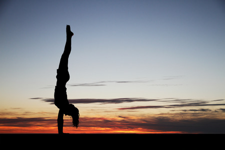 handstand in sunsetの写真素材
