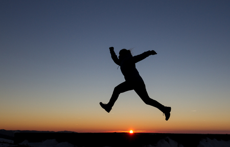 girl runs in sunsetの写真素材