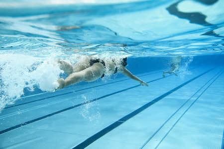 woman swimming in outdoor pool woman swimming in outdoor pool
